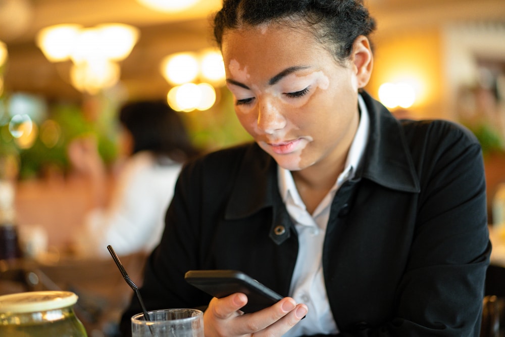 A small business woman confidently sending new subscribers details about her business as her business grows.